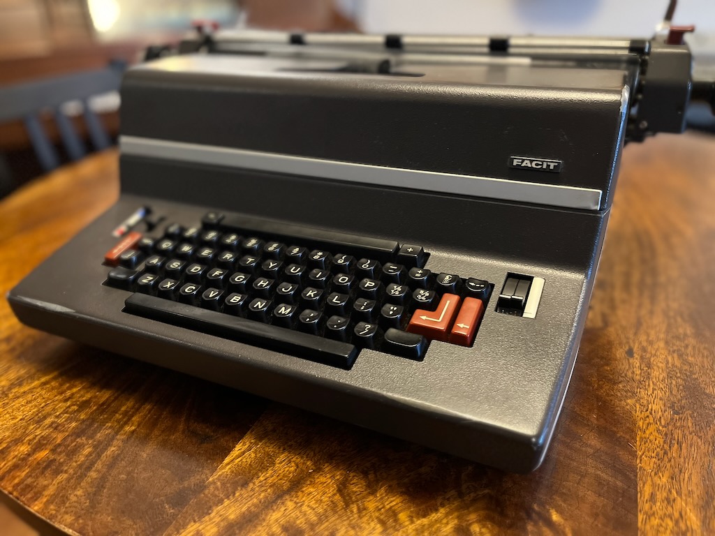 Restored vintage Facit electric typewriter with black and grey body and red accent keys